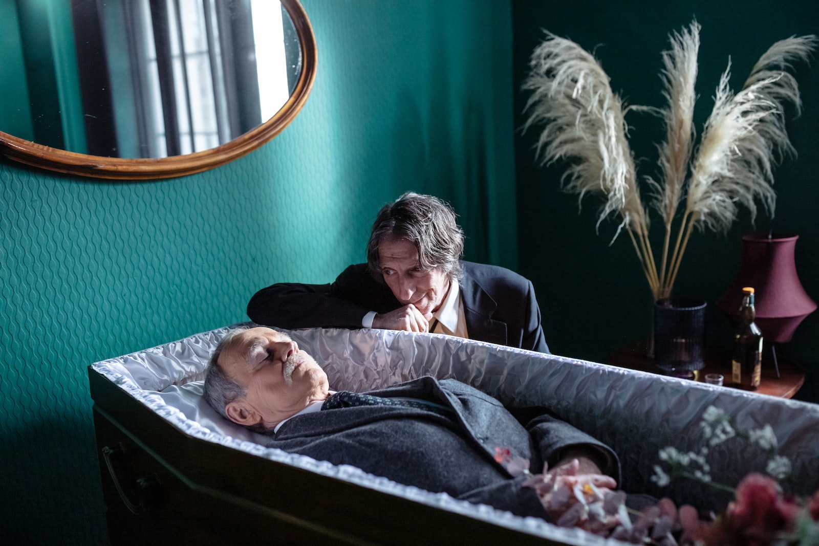 Man Looking at Dead Body in Coffin