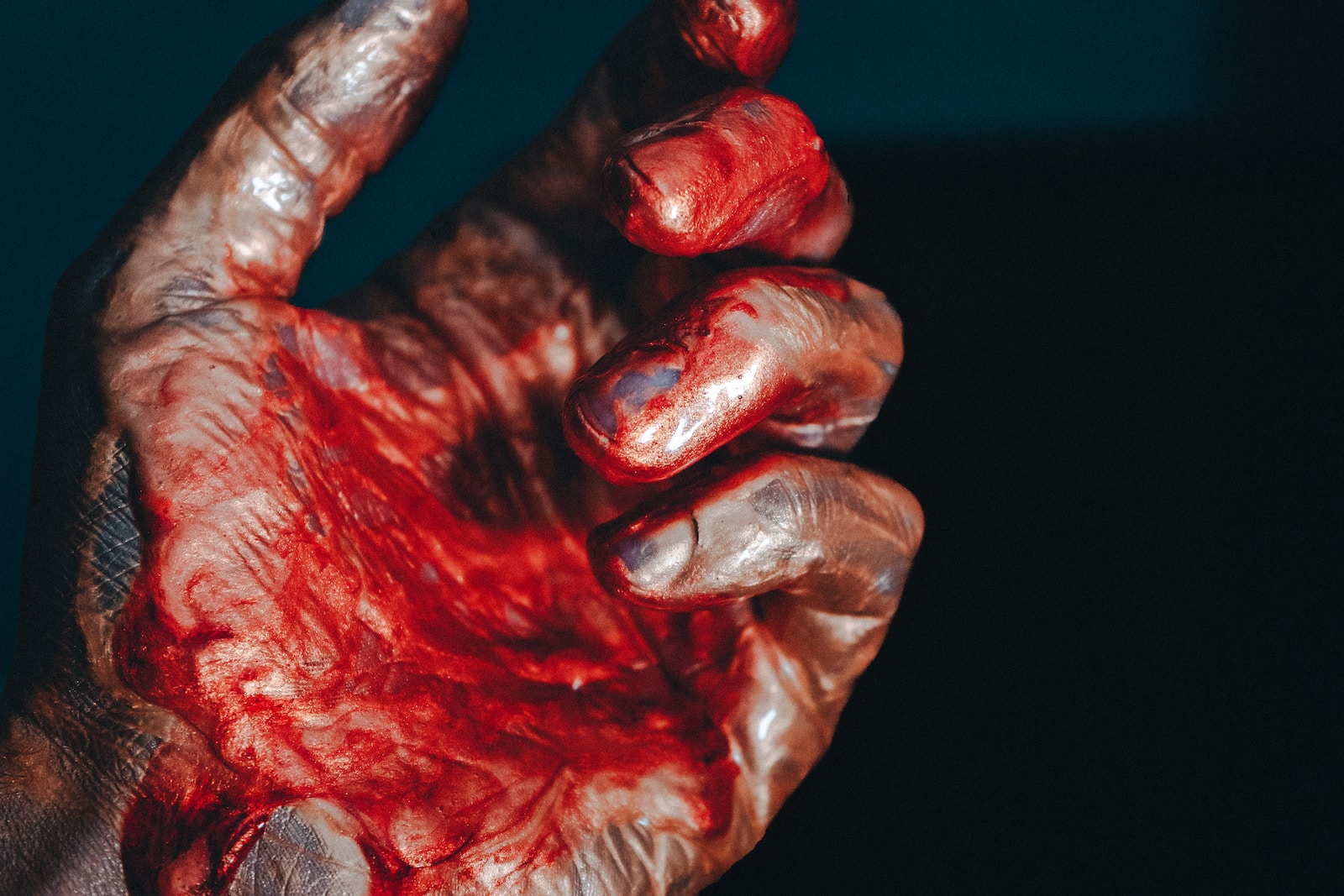 a person's hand with blood on it