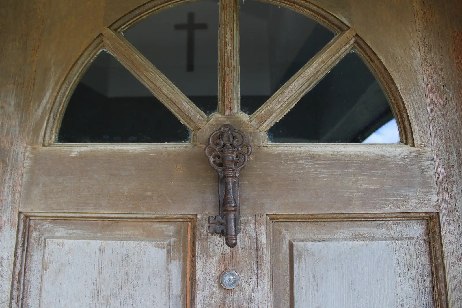 a close up of a door with a cross on it