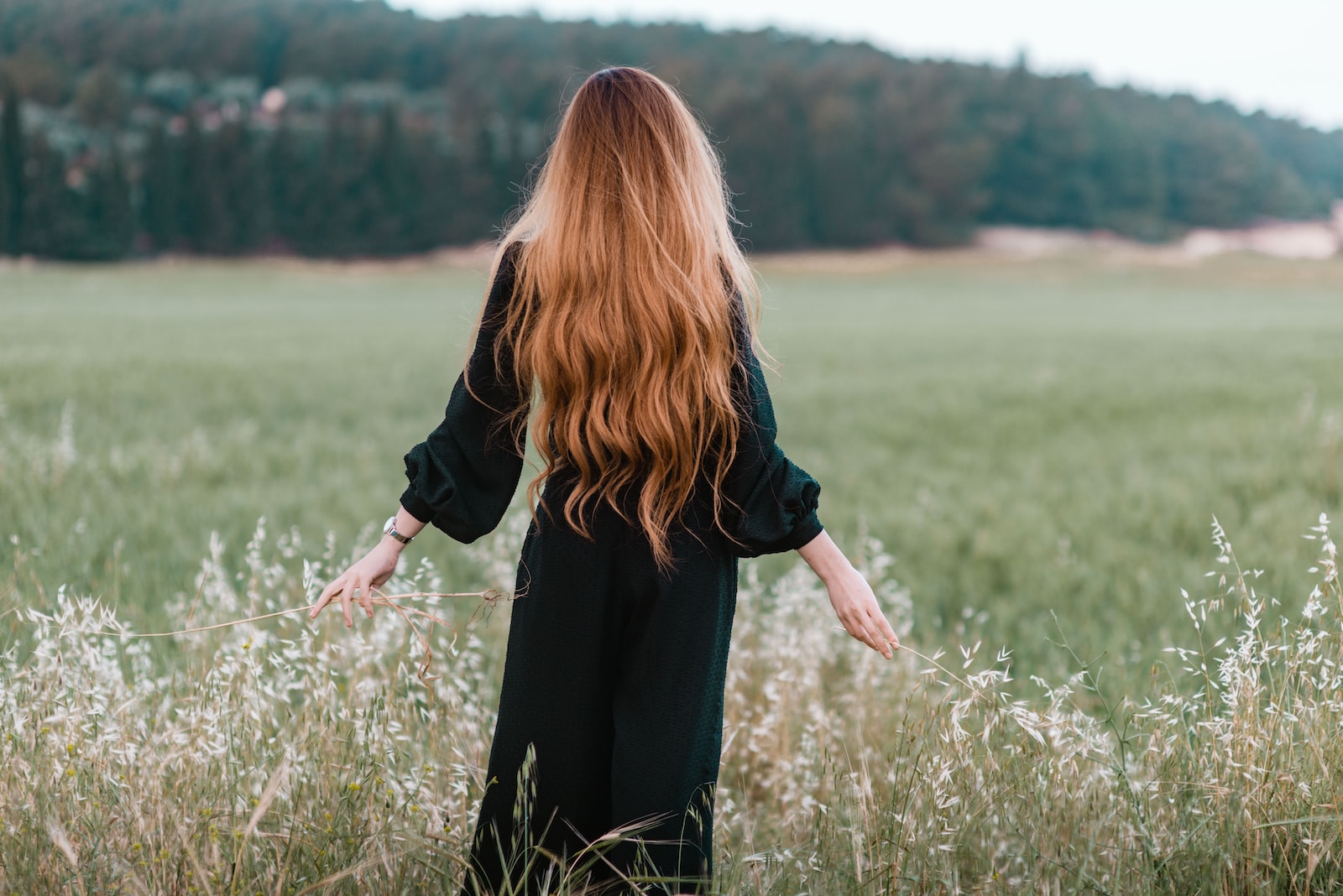 woman standing on green grass field during daytime